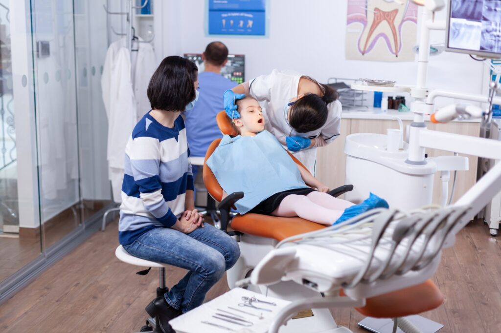 Little girl in the course of treatment for caries