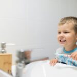 Adorable child brushing his teeth