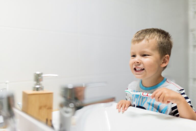 Adorable child brushing his teeth