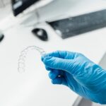 Doctor hand holding a clear dental aligner